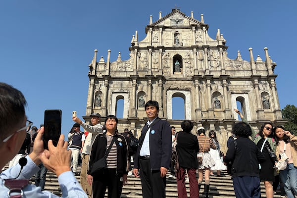 Mainland Chinese tourists take photos in front of the Ruins of St. Paul's in Macao on Dec. 13, 2024. (AP Photo/Kanis Leung)