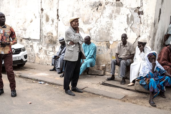 People wait to cast their ballot for legislative elections in Dakar, Senegal Sunday, Nov. 17, 2024. (AP Photo/Annika Hammerschlag)