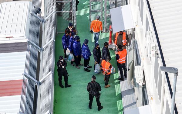 An aerial photograph taken by a drone shows migrants entering a detention center for processing following earlier court rejections, in the port of Shengjin, northwestern Albania, Tuesday, Jan. 28, 2025. (AP Photo/Vlasov Sulaj)