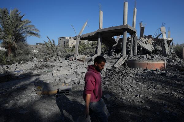 A Palestinian walks past a destroyed building following an overnight Israeli strike in Deir al-Balah, Gaza Strip, Wednesday, Dec. 4, 2024. (AP Photo/Abdel Kareem Hana)