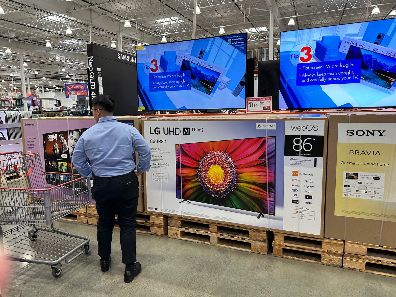 FILE - A shopper considers large-screen televisions on display in a Costco warehouse Oct. 3, 2024, in Timnath, Colo. (AP Photo/David Zalubowski, File)