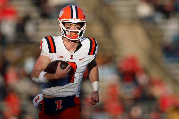 Illinois quarterback Luke Altmyer (9) runs for a 31-yard touchdown against Rutgers during the second half of an NCAA college football game, Saturday, Nov. 23, 2024, in Piscataway, N.J. Illinois defeated Rutgers 38-31. (AP Photo/Rich Schultz)