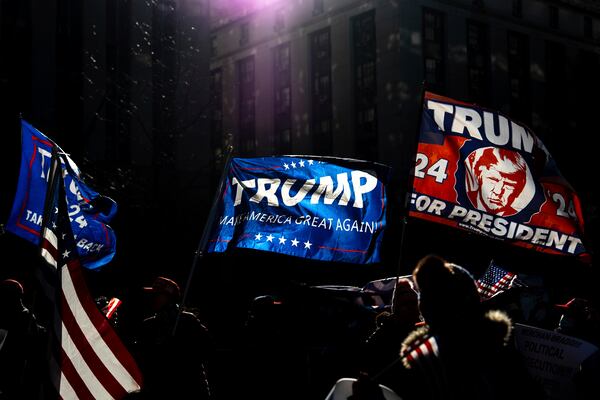 FILE - Demonstrators wave MAGA flags outside the Manhattan criminal court following the sentencing in President-elect Donald Trump's hush money case, in New York, Jan. 10, 2025. (AP Photo/Julia Demaree Nikhinson, File)