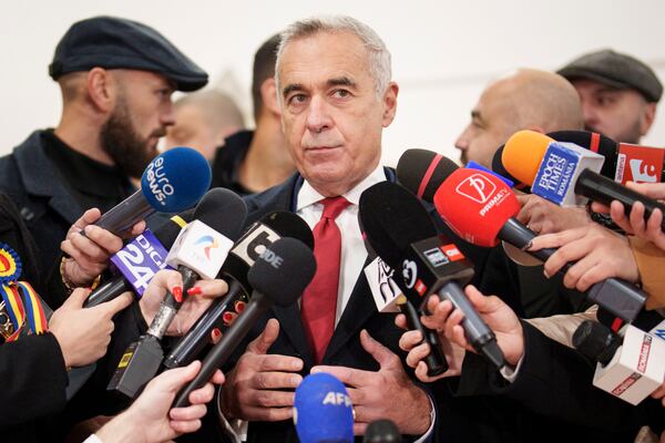 Calin Georgescu, an independent candidate for president who came first after the first round of presidential elections, speaks to media after casting his vote in the country's parliamentary elections, in Mogosoaia, Romania, Sunday, Dec. 1, 2024. (AP Photo/Vadim Ghirda)