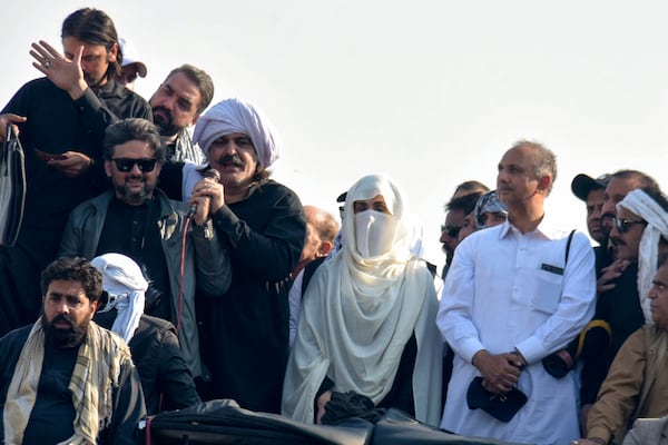 Bushra Bibi, center, wife of imprisoned former premier Imran Khan and leaders of Khan's party lead their supporters during a rally demanding Khan's release, in Islamabad, Pakistan, Tuesday, Nov. 26, 2024. (AP Photo/W.K. Yousufzai)