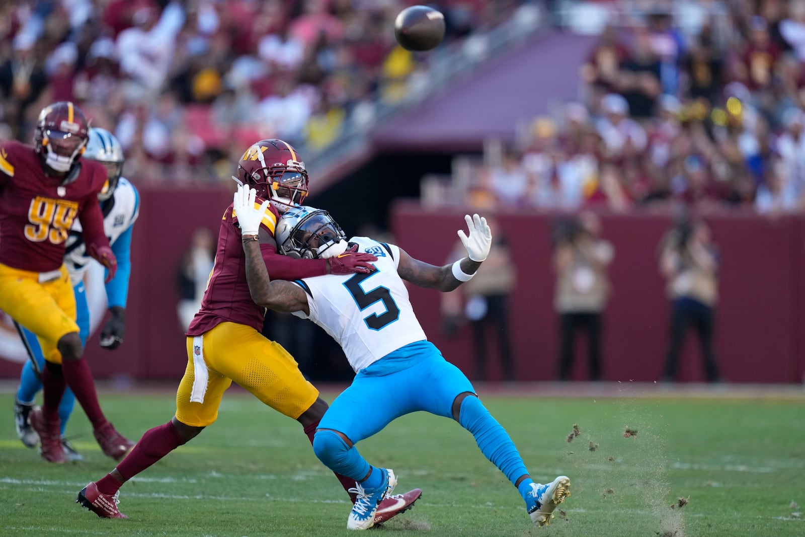 Washington Commanders linebacker Dante Fowler Jr. breaks up a pass intended for Carolina Panthers wide receiver Diontae Johnson (5) during the first half of an NFL football game, Sunday, Oct. 20, 2024, in Landover, Md. (AP Photo/Stephanie Scarbrough)