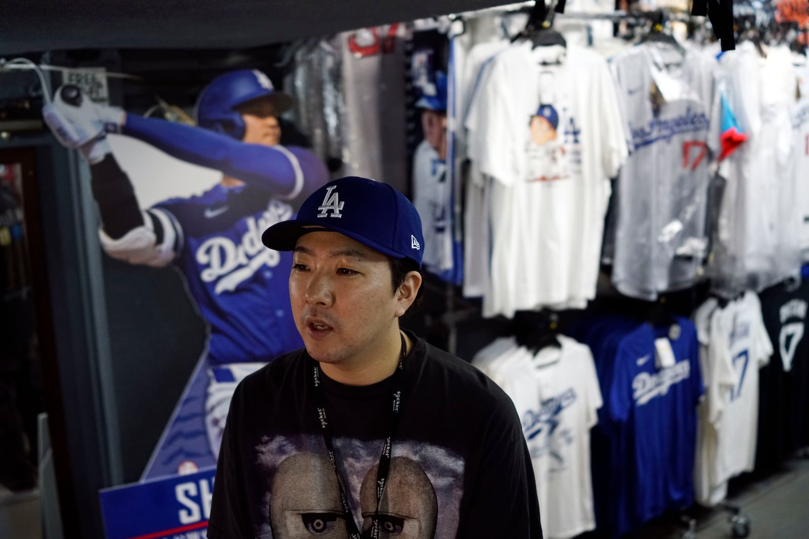 Store manager Takeru Watanabe speaks in front of goods related to Shohei Ohtani of the Los Angeles Dodgers at a sporting goods store, "SELECTION," in Shinjuku district Wednesday, Oct. 23, 2024 in Tokyo. (AP Photo/Eugene Hoshiko)