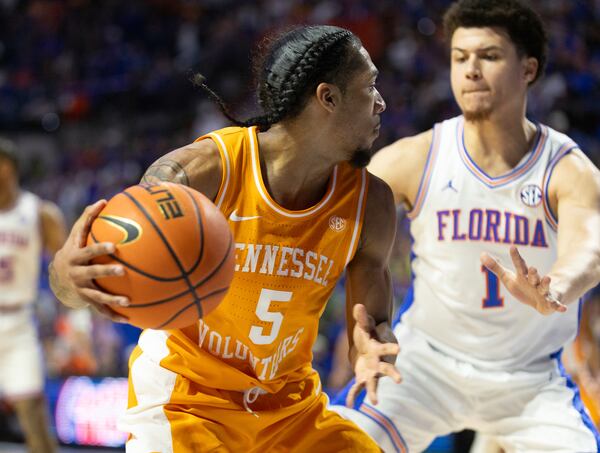 Tennessee guard Zakai Zeigler (5) drives on Florida guard Walter Clayton Jr. (1) during the first half of an NCAA college basketball game Tuesday, Jan. 7, 2025, in Gainesville, Fla. (AP Photo/Alan Youngblood)