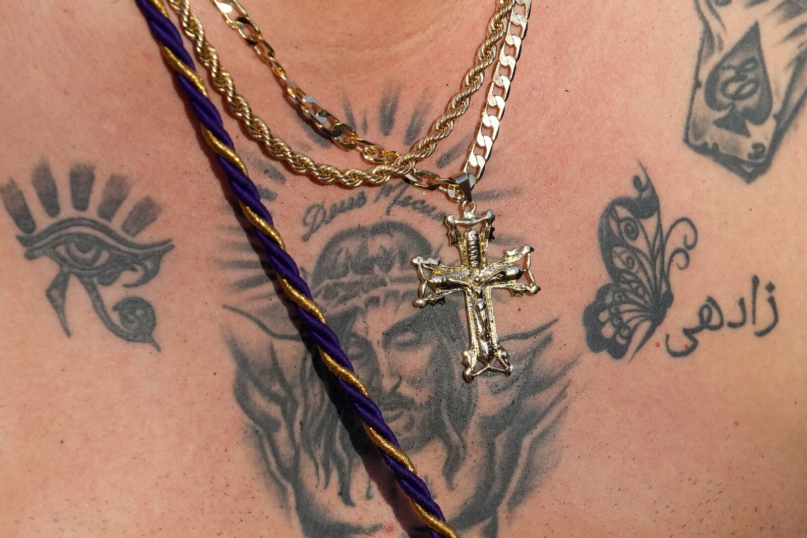 A tattoo of Christ covers the chest of pilgrim Ernesto Troya who crawls to San Felipe Church to honor the Black Christ in Portobelo, Panama, Monday, Oct. 21, 2024, during a festival celebrating the statue that was found on the shore in 1658. (AP Photo/Matias Delacroix)