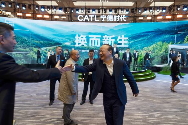 Robin Zeng, the CEO of China-based CATL battery manufacturing company, greets a guest after a launch event for the next generation of swap stations, in Xiamen, Fujian province, China, Wednesday, Dec. 18, 2024. (AP Photo/Ng Han Guan)