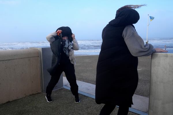 Two women brave the wind as Storm Eowyn hits the country in Cleveleys, near Blackpool, England, Friday, Jan. 24, 2025.(AP Photo/Jon Super)