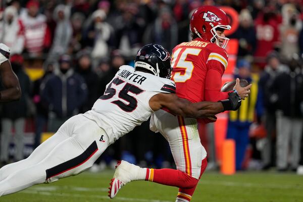 Kansas City Chiefs quarterback Patrick Mahomes (15) is stopped by Houston Texans defensive end Danielle Hunter (55) during the second half of an NFL football AFC divisional playoff game Saturday, Jan. 18, 2025, in Kansas City, Mo. (AP Photo/Ed Zurga)