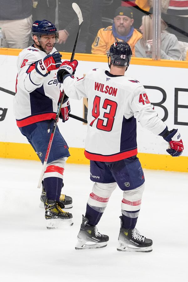 Washington Capitals left wing Alex Ovechkin (8) celebrates his empty net goal with right wing Tom Wilson (43) during the third period of an NHL hockey game against the Nashville Predators, Saturday, Jan. 11, 2025, in Nashville, Tenn. The Capitals won 4-1. (AP Photo/George Walker IV)