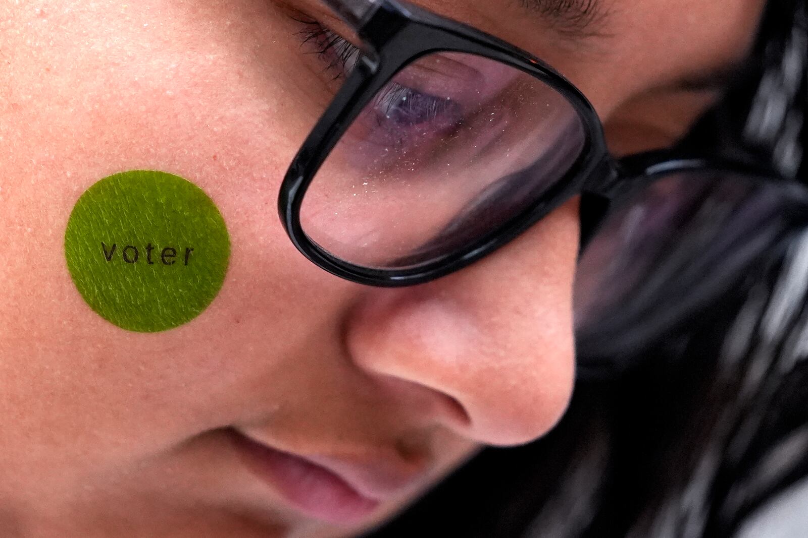 Hirieth Cervantes, freshman music major in Columbia College Chicago, waits to vote outside Chicago City Loop Super Site polling place on Election Day in Chicago, Tuesday, Nov. 5, 2024. (AP Photo/Nam Y. Huh)