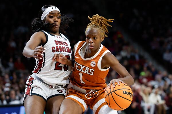 Texas guard Bryanna Preston (1) drives against South Carolina guard Raven Johnson during the second half of an NCAA college basketball game in Columbia, S.C., Sunday, Jan. 12, 2025. (AP Photo/Nell Redmond)