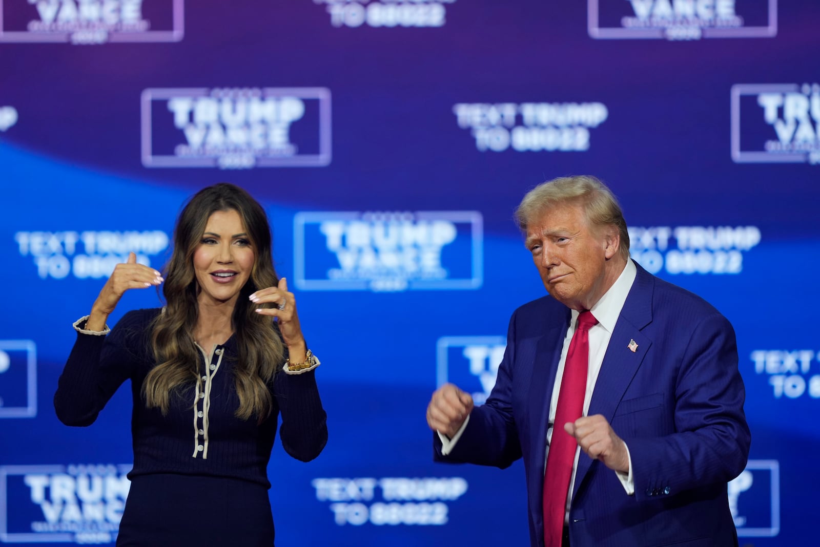 Republican presidential nominee former President Donald Trump and South Dakota Gov. Kristi Noem dance to the song "Y.M.C.A." at a campaign town hall at the Greater Philadelphia Expo Center & Fairgrounds, Monday, Oct. 14, 2024, in Oaks, Pa. (AP Photo/Matt Rourke)