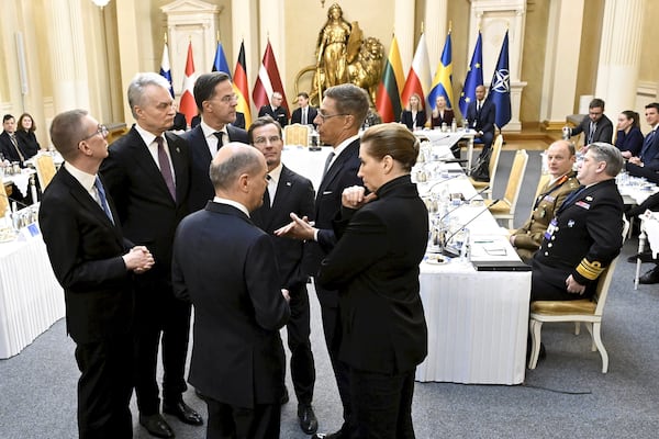 German Chancellor Olaf Scholz, front left, and Denmark's Prime Minister Mette Frederiksen, front right, talk during a summit of the Baltic Sea NATO countries in Helsinki, Finland, Tuesday, Jan. 14, 2025. (Vesa Moilanen/Lehtikuva via AP)