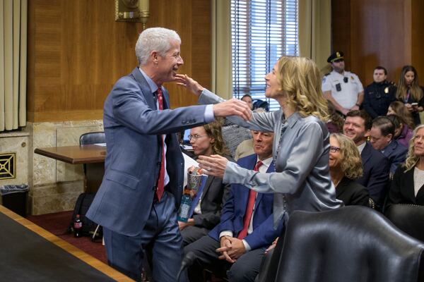 Chris Wright, President-elect Donald Trump's nominee to be Secretary of Energy, left, reaches out to hug his wife Liz Wright as he arrives for Senate Committee on Energy and Natural Resources hearing for his pending confirmation, on Capitol Hill, Wednesday, Jan. 15, 2025, in Washington. (AP Photo/Rod Lamkey, Jr.)