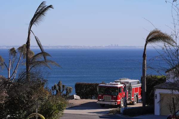 A firetruck drives up a road in Malibu, Calif., Sunday, Jan. 12, 2025. (AP Photo/Mark J. Terrill)