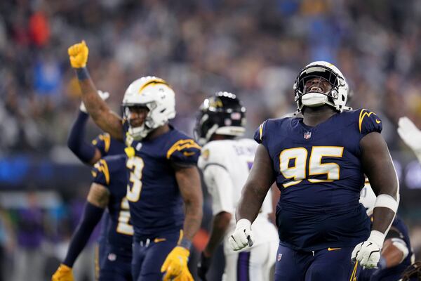 Los Angeles Chargers defensive tackle Poona Ford (95) celebrates after a defensive stop during the first half of an NFL football game against the Baltimore Ravens, Monday, Nov. 25, 2024, in Inglewood, Calif. (AP Photo/Eric Thayer)