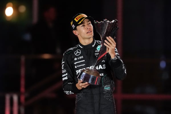 Mercedes driver George Russell, of Britain, celebrates on the podium after winning the F1 Las Vegas Grand Prix auto race, Sunday, Nov. 24, 2024, in Las Vegas. (AP Photo/Matt York)