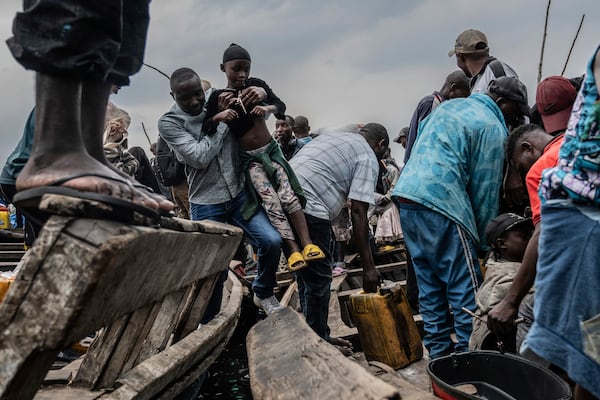 People fleeing M-23 rebel advances arrive by boat in Goma, Democratic Republic of the Congo, Wednesday, Jan. 22, 2025. (AP Photo/Moses Sawasawa)