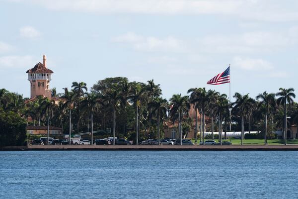 The U.S. flag is shown at the Mar-a-Lago compound in Palm Beach, Fla., while a U.S. Coast Guard boat patrols around the vicinity, Monday, Jan. 13, 2025. U.S. flags at President-elect Donald Trump's private Mar-a-Lago club are back to flying at full height. Flags are supposed to fly at half-staff through the end of January out of respect for former President Jimmy Carter, who died Dec. 29. (AP Photo/Manuel Balce Ceneta)