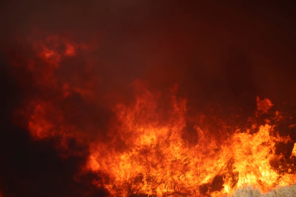 Flames caused by the Hughes Fire engulf mountain brush in Castaic, Calf., Wednesday, Jan. 22, 2025. (AP Photo/Ethan Swope)