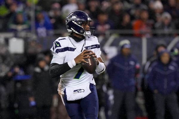 Seattle Seahawks quarterback Geno Smith looks to pass against the Chicago Bears during the first half of an NFL football game, Thursday, Dec. 26, 2024, in Chicago. (AP Photo/Nam Y. Huh)