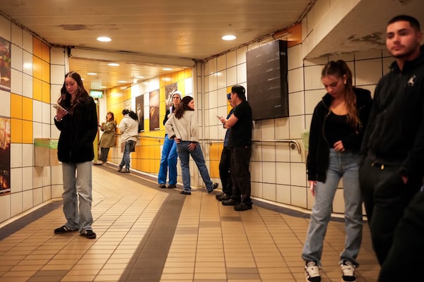 People take shelter in a metro station as a siren sounds a warning of incoming rockets from Lebanon in Haifa, Tuesday, Nov. 26, 2024. (AP Photo/Francisco Seco)