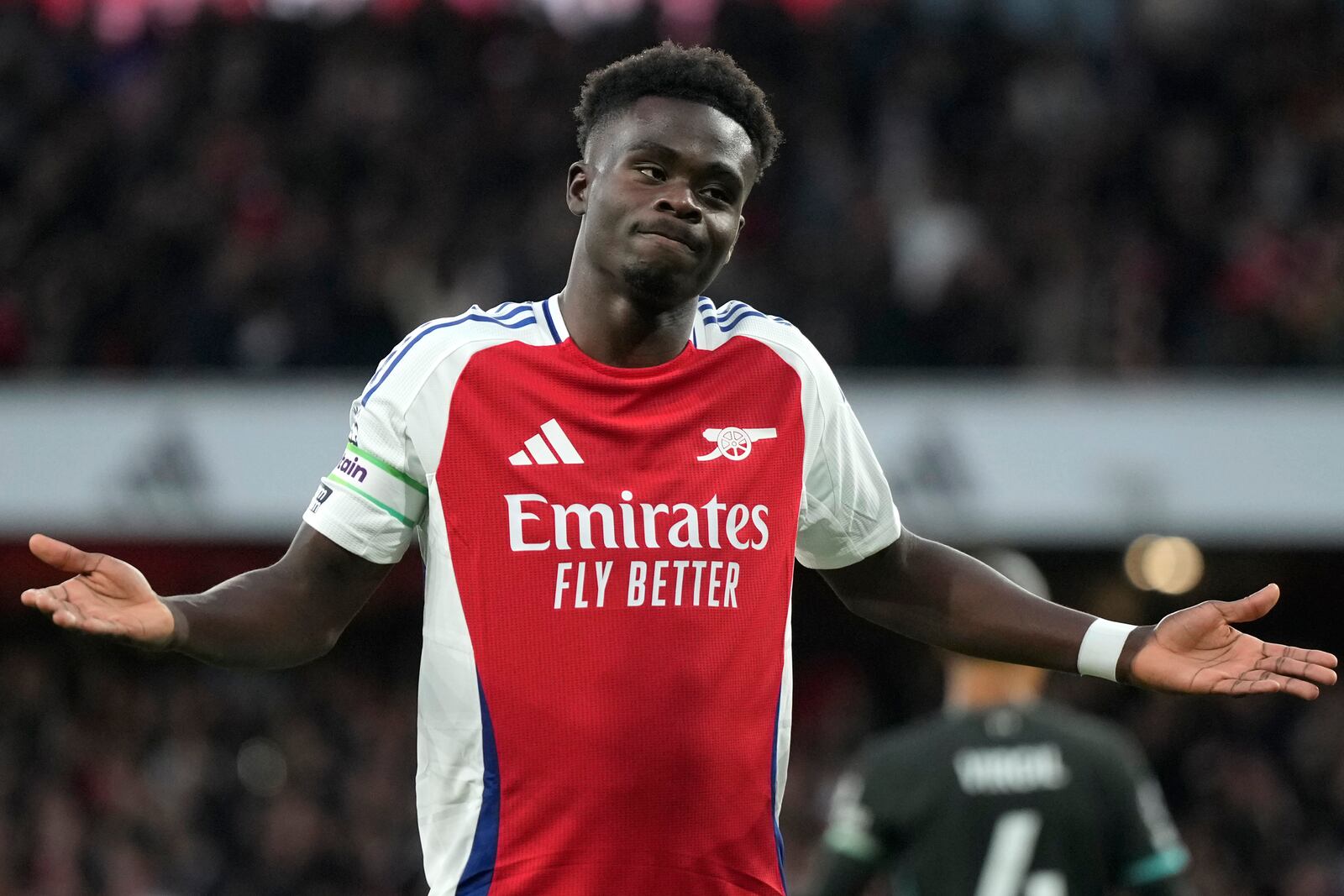 Arsenal's Bukayo Saka celebrates after scoring his side's opening goal during the English Premier League soccer match between Arsenal and Liverpool, at Emirates Stadium in London, England, Sunday, Oct. 27, 2024. (AP Photo/Alastair Grant)