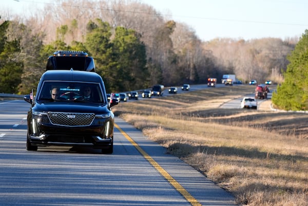 The hearse containing the flag-draped casket of former President Jimmy Carter travels in the motorcade from Lawson Army Airfield, in Fort Moore, Ga., to Maranatha Baptist Church in Plains, Ga., Thursday, Jan. 9, 2025. (AP Photo/Alex Brandon, Pool)