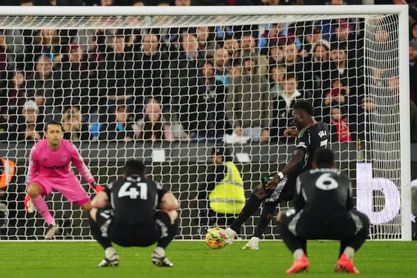 Arsenal's Bukayo Saka scores his side's fifth goal during the English Premier League soccer match between West Ham and Arsenal at the London Stadium in London, Saturday, Nov. 30, 2024. (AP Photo/Dave Shopland)