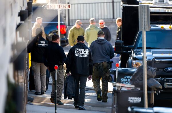 Investigators search a townhouse in northeastern Colorado Springs, Colo., Thursday, Jan. 2, 2025, as the investigation connected to the explosion of a Tesla Cybertruck outside President-elect Donald Trump's Las Vegas hotel continues. (Parker Seibold /The Gazette via AP)