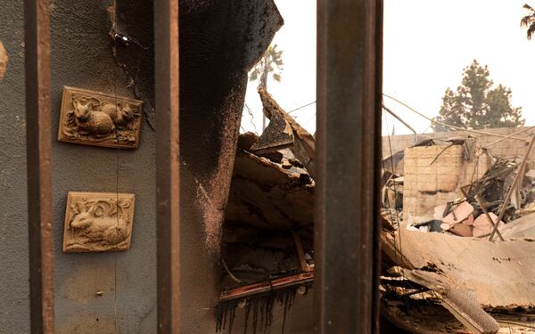 Wall art at left featuring bunnies is suspended on a charred wall at the destroyed Bunny Museum, Thursday, Jan. 9, 2025, in the Altadena section of Pasadena, Calif. (AP Photo/Chris Pizzello)