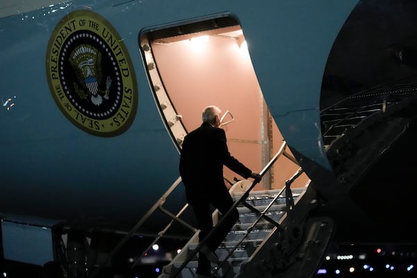 President Joe Biden boards Air Force One at Joint Base Andrews, Md., Sunday, Dec. 1, 2024, en route to Angola as he makes his long-promised visit to Africa. (AP Photo/Ben Curtis)