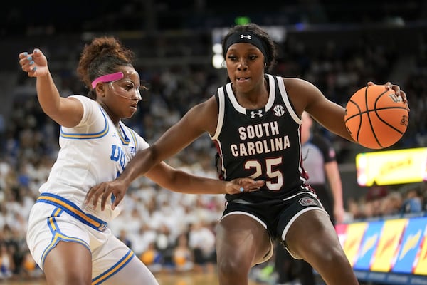 South Carolina guard Raven Johnson (25) dribbles against UCLA guard Londynn Jones (3) during the first half of an NCAA college basketball game, Sunday, Nov. 24, 2024, in Los Angeles. (AP Photo/Eric Thayer)