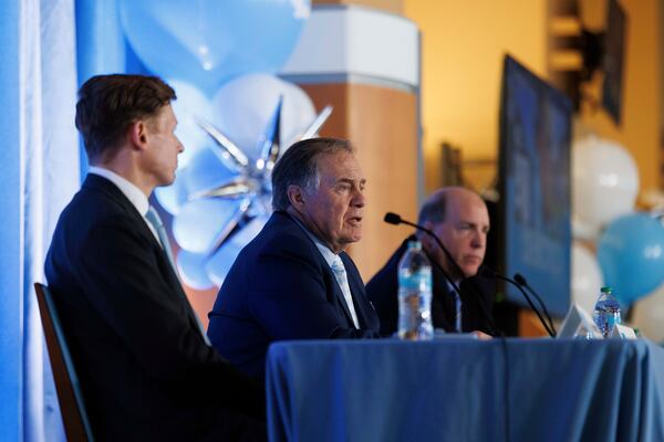 New North Carolina football coach Bill Belichick, center, speaks as University of North Carolina Chancellor Lee Roberts, left, and athletic director Bubba Cunningham, right, look on during an NCAA college football press conference in Chapel Hill, N.C., Thursday, Dec. 12, 2024. (AP Photo/Ben McKeown)