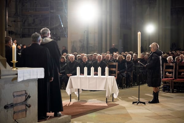 German President Frank-Walter Steinmeier, center, and Chancellor Olaf Scholza, center left, attend a memorial service for victims of Friday's Christmas Market attack, where a car drove into a crowd, in Magdeburg, Germany, Saturday, Dec. 21, 2024. (AP Photo/Ebrahim Noroozi)