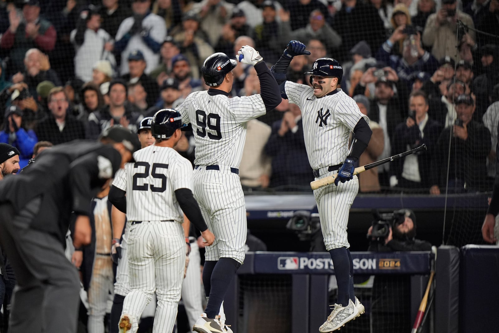 New York Yankees' Aaron Judge (99) celebrates with Austin Wells after hitting a two-run home run against the Cleveland Guardians during the seventh inning in Game 2 of the baseball AL Championship Series Tuesday, Oct. 15, 2024, in New York. (AP Photo/Frank Franklin II)