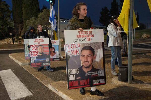 Israeli demonstrators outside the prime minister's office in Jerusalem hold photos of the hostages during a protest calling for the release of hostages held in the Gaza Strip by the Hamas militant group, Sunday, Jan. 5, 2025. (AP Photo/Ohad Zwigenberg)