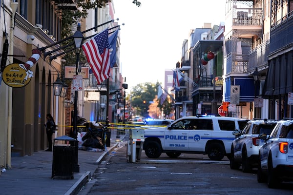 Emergency service vehicles form a security barrier to keep other vehicles out of the French Quarter after a vehicle drove into a crowd on New Orleans' Canal and Bourbon Street, Wednesday Jan. 1, 2025. (AP Photo/Gerald Herbert)