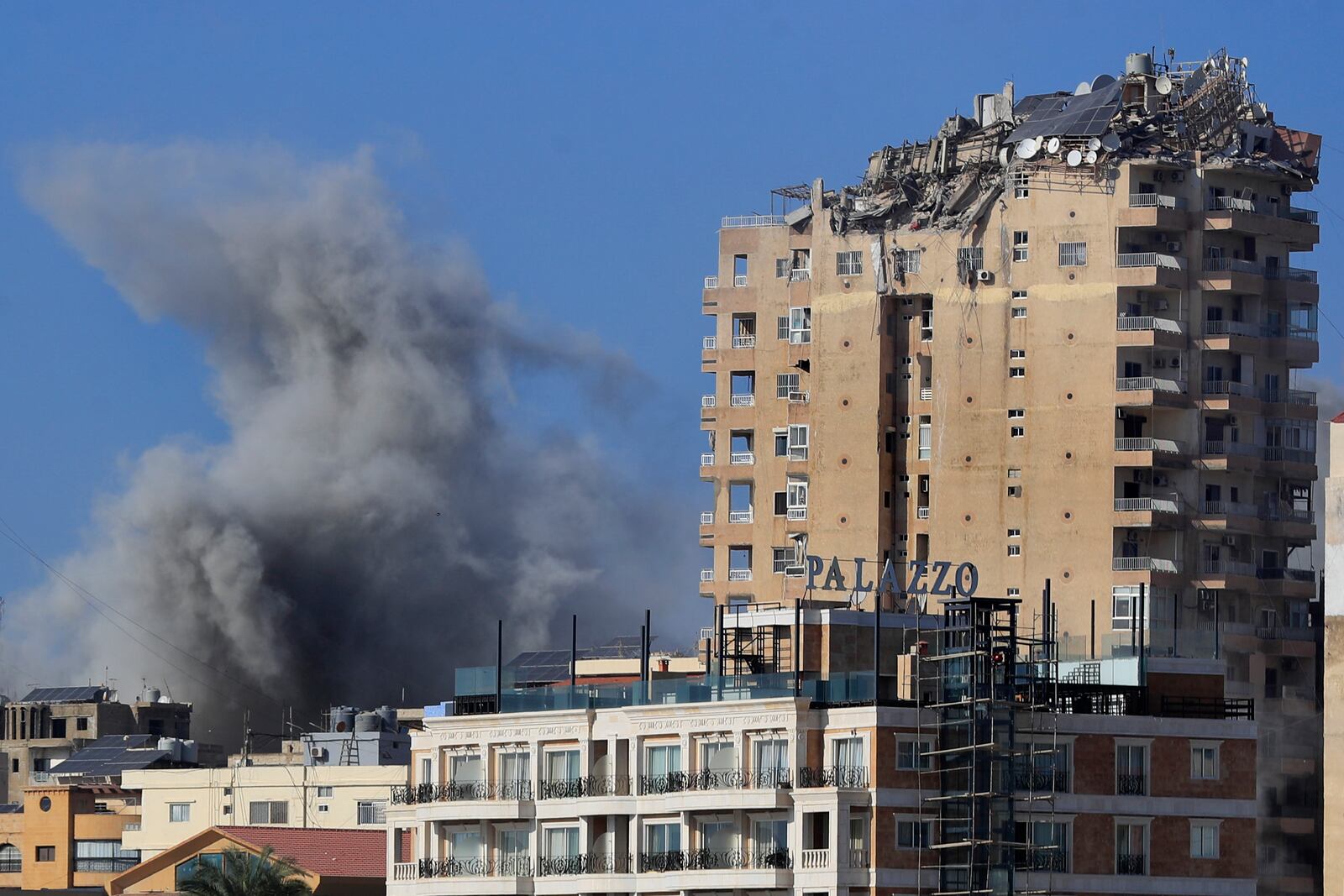 Smoke rises next of a destroyed building hit in an Israeli airstrike in Tyre, southern Lebanon, Monday, Oct. 28, 2024.(AP Photo/Mohammad Zaatari)