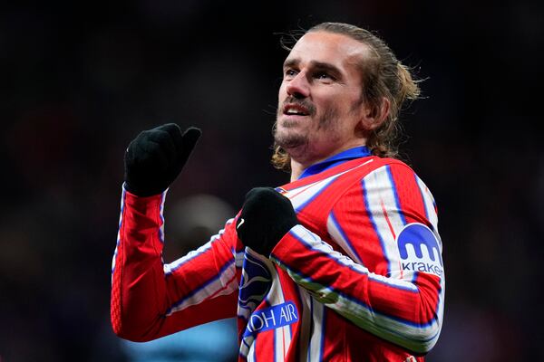 Atletico Madrid's Antoine Griezmann celebrates after scoring his side's third goal during the Champions League opening phase soccer match between Atletico Madrid and Slovan Bratislava at Riyadh Air Metropolitano stadium in Madrid, Spain, Wednesday, Dec. 11, 2024. (AP Photo/Manu Fernandez)