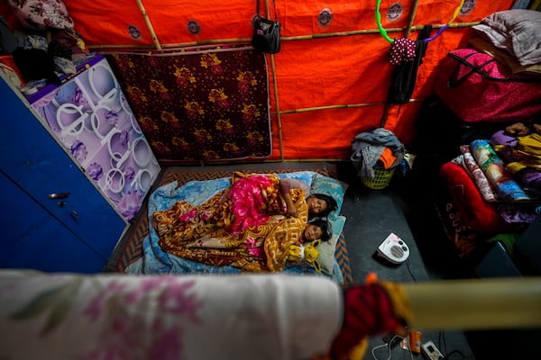 A Kuki tribal woman and her daughter rest in a relief camp in Kangpokpi, Manipur, Sunday, Dec. 15, 2024. (AP Photo/Anupam Nath)