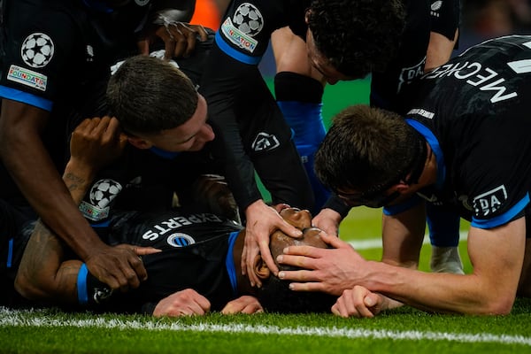 Brugge's Raphael Onyedika, bottom, celebrates with teammates after scoring the opening goal during the Champions League opening phase soccer match between Manchester City and Club Brugge at the Etihad Stadium in Manchester, Wednesday, Jan. 29, 2025. (AP Photo/Dave Thompson)