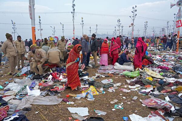 Hindu devotees search for their belongings after a stampede when Hindu devotees rushed to take a holy bath in the Sangam, the confluence of the Ganges, the Yamuna and the mythical Saraswati rivers, on "Mauni Amavasya" or new moon day during the Maha Kumbh festival in Prayagraj, India, Wednesday, Jan. 29, 2025. (AP Photo/Deepak Sharma)