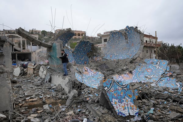 A man checks a destroyed mosque, following a ceasefire between Israel and Hezbollah that went into effect on Wednesday, Nov. 27, 2024, in Ainata village, southern Lebanon. (AP Photo/Hussein Malla)