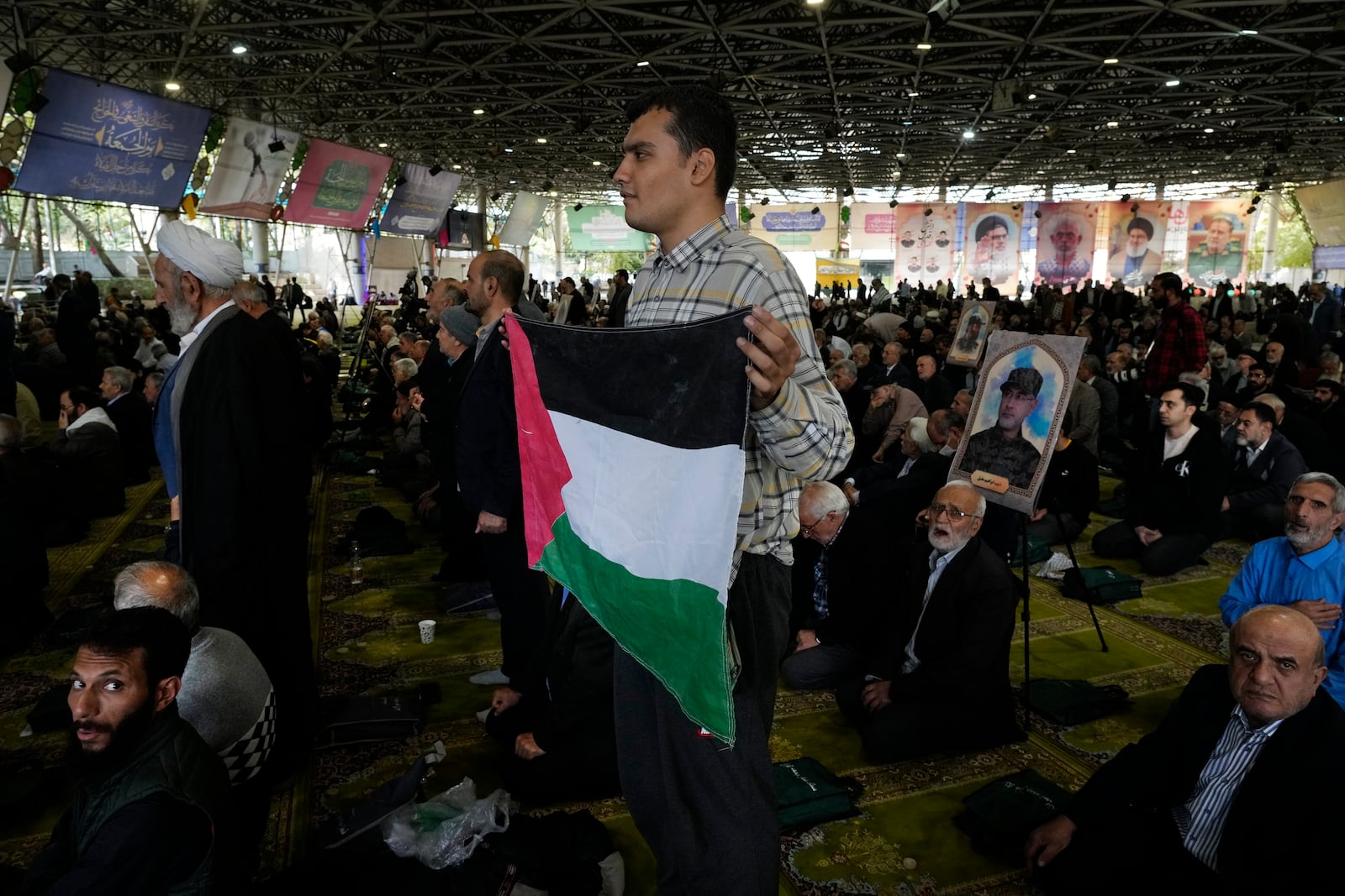 An Iranian worshipper holds a Palestinian flag during Friday prayer ceremony at the Tehran University campus, in Tehran, Iran, Friday, Nov. 8, 2024. (AP Photo/Vahid Salemi)