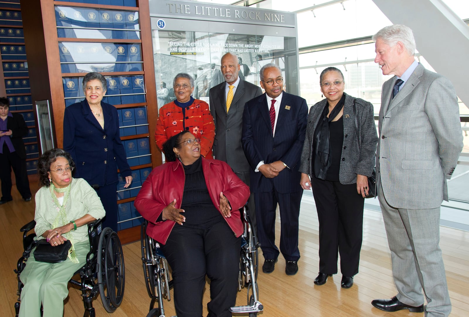 FILE - Members of the Little Rock Nine, standing from left, Carlotta Walls LaNier, Minnijean Brown-Trickey, Terrence Roberts, Ernest Green, Gloria Ray Karlmark, and foreground seated, Thelma Mothershed Wair and Melba Pattillo Beals speak with former President Bill Clinton, right, at the William J. Clinton Presidential Library, Feb. 19, 2011, in Little Rock, Ark. (AP Photo/Brian Chilson, File)